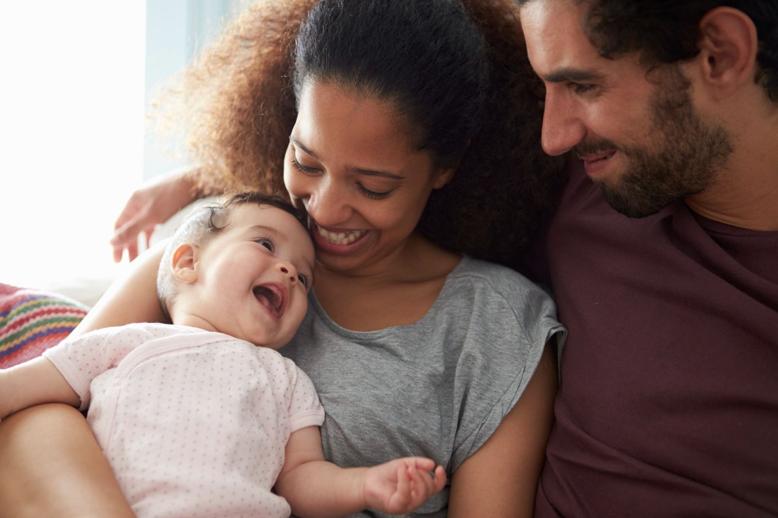Happy family at home with their ADT-monitored security system