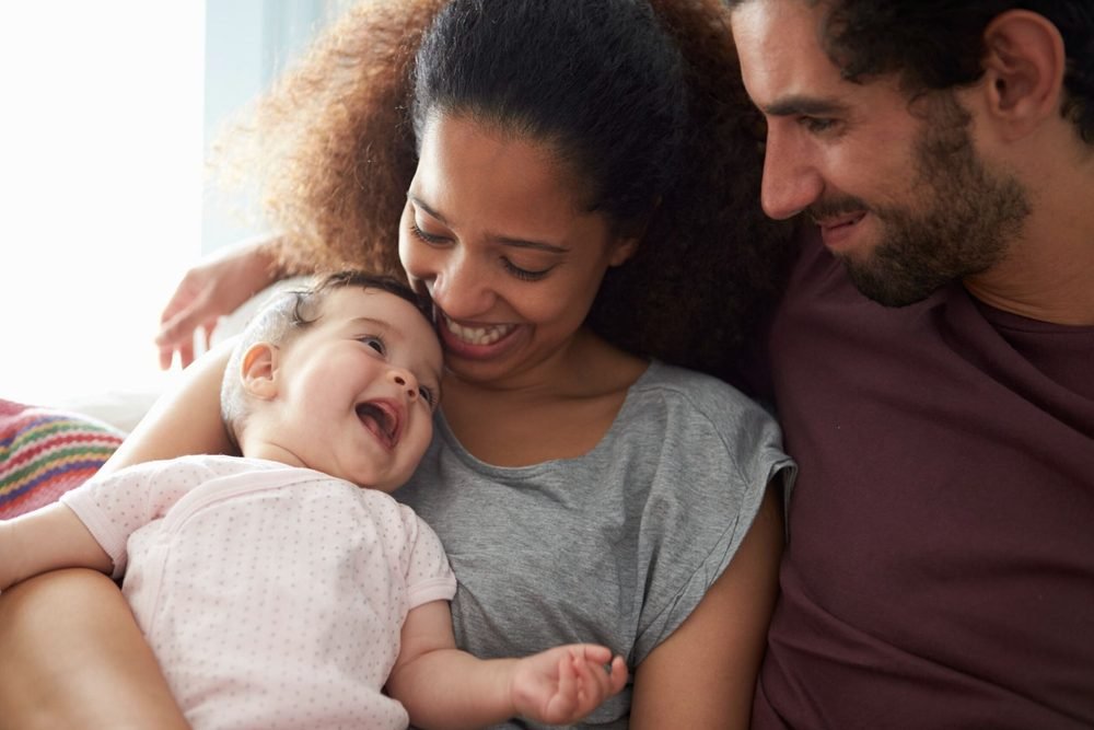 Happy family at home with their ADT-monitored security system